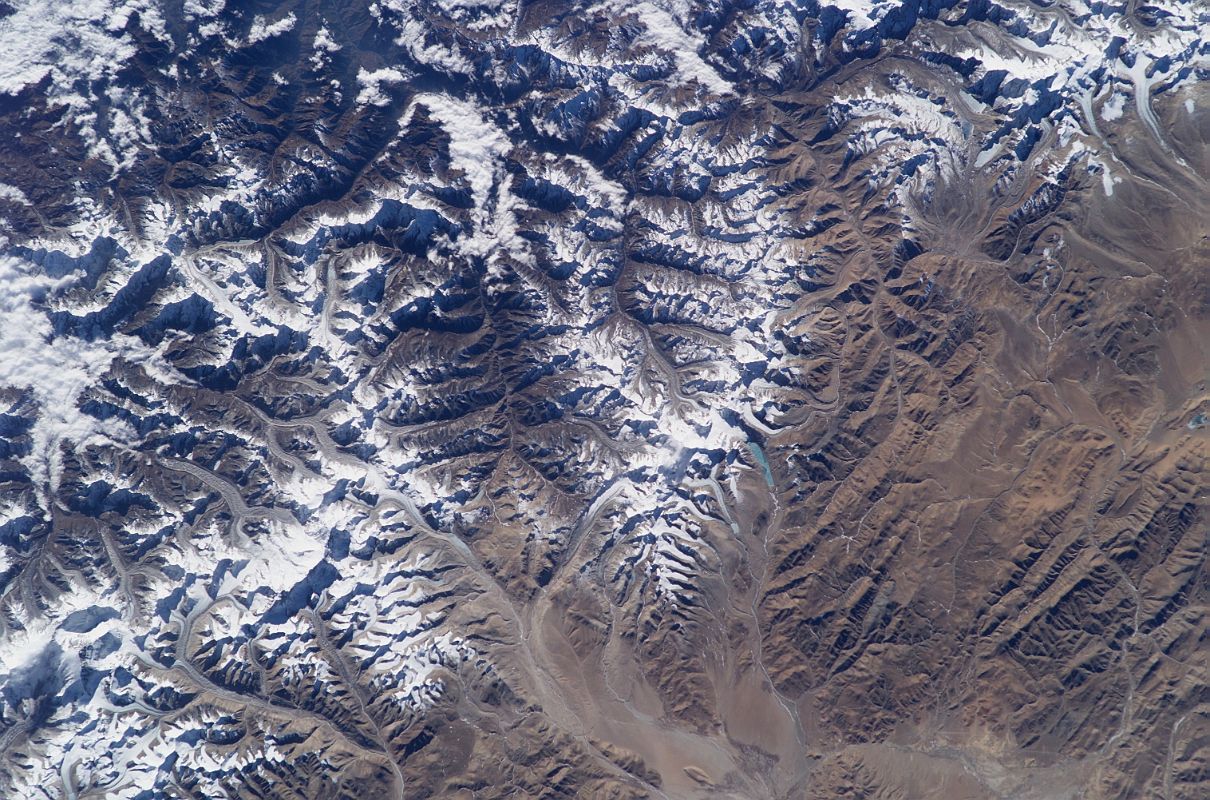Shishapangma 02 05 Nasa ISS006-E-13651 Shishapangma to Cho Oyu Nasa ISS006-E-13651 was taken on 2002-12-28. Shishapangma is in the upper right corner and Cho Oyu is in the lower left corner. To the left of Cho Oyu is the Gokyo Valley in Nepal. The Labuche Kang massif is in the lower centre near the lake, about half-way between Cho Oyu and Shishapangma. Gauri Shankar (7143m) is on the long left-to-right ridge in shadow to the left of centre, with Menlungtse (7181m), the spiky peak just below it.